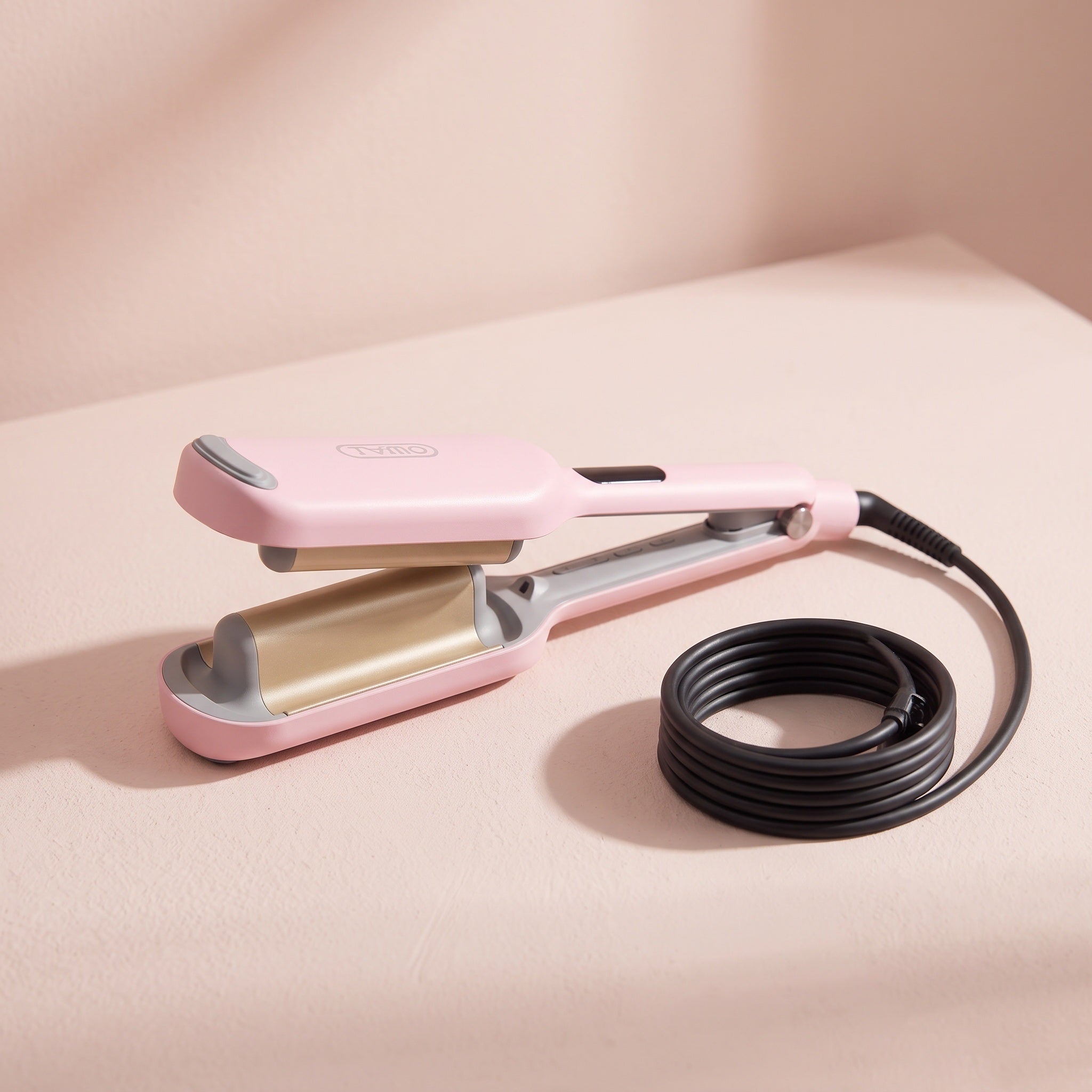 One pink 32mm (1.25 in) waver with its attached power cord