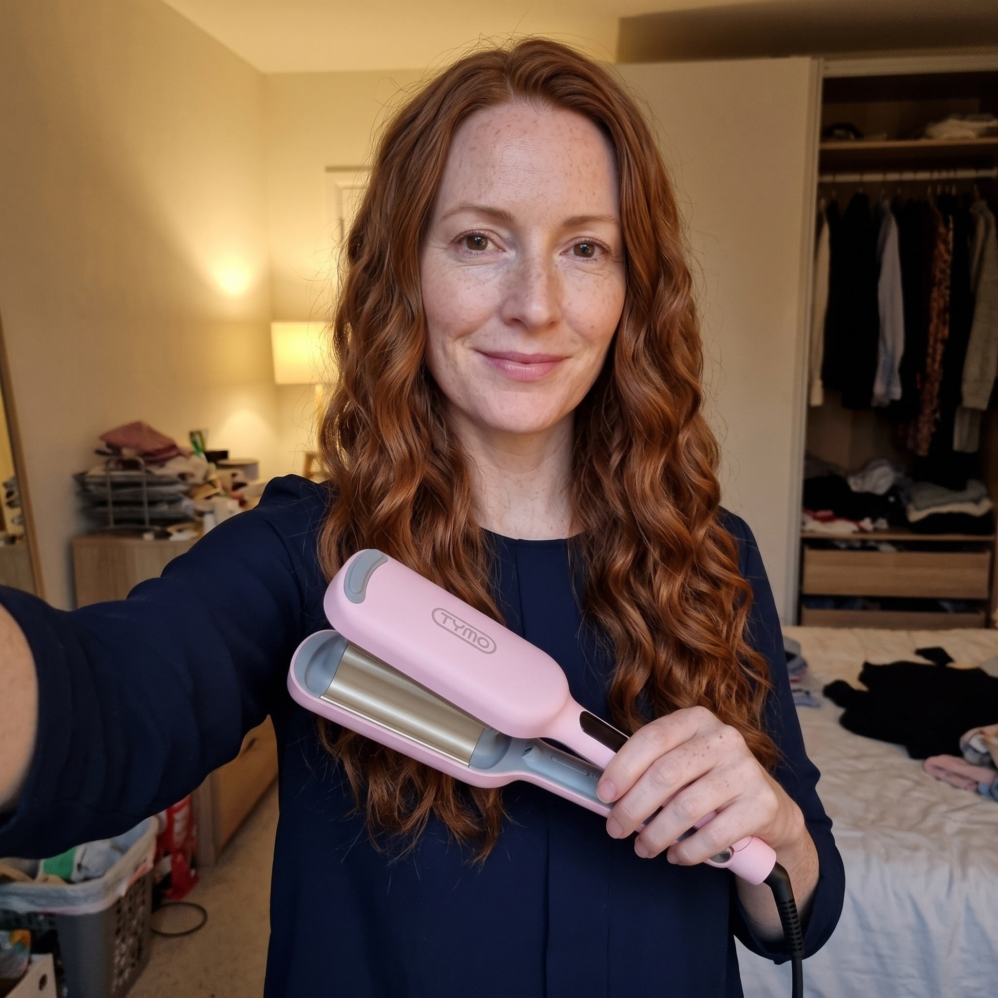 Pink waver resting on a dressing table before styling