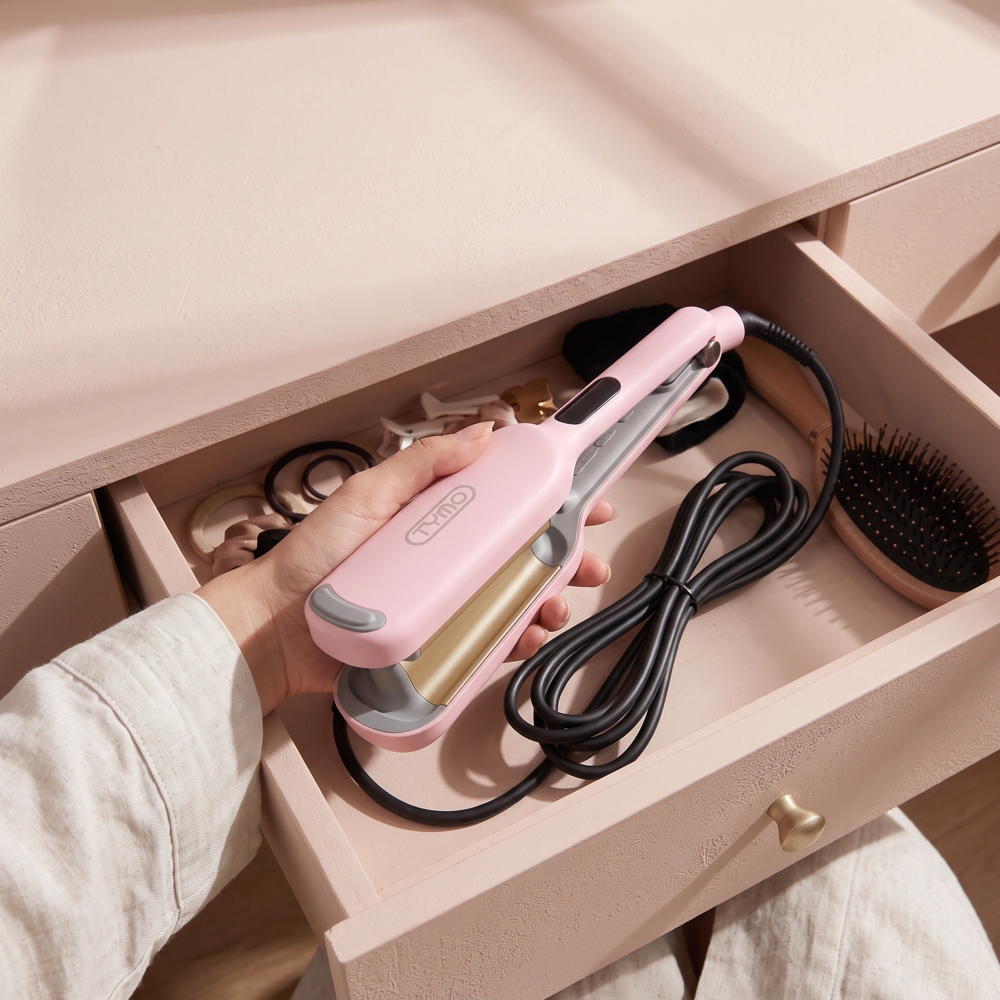 Cooled pink waver being placed in a bedroom drawer
